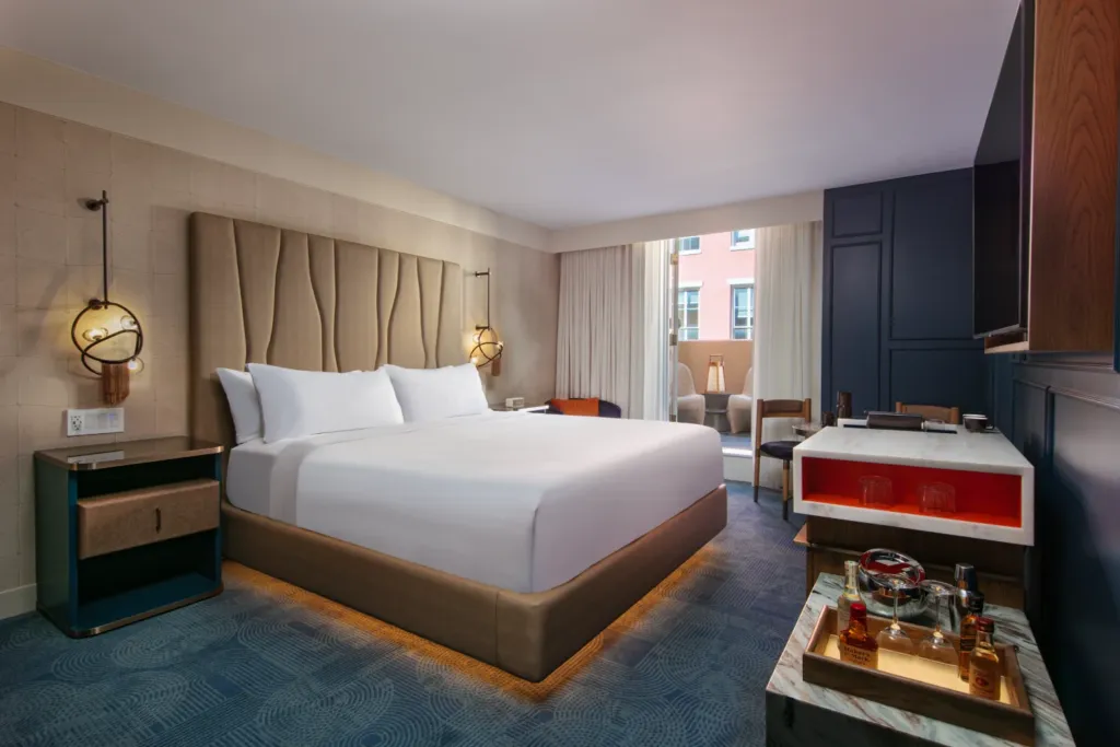 a hotel room with a large bed and a flat screen tv
