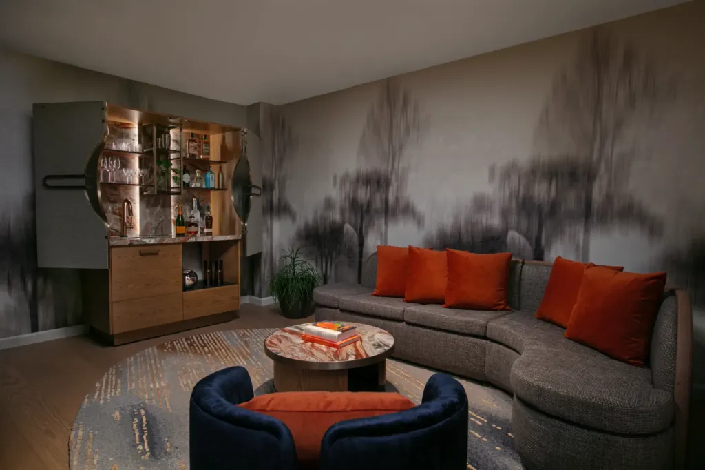 a living room filled with furniture and a bar