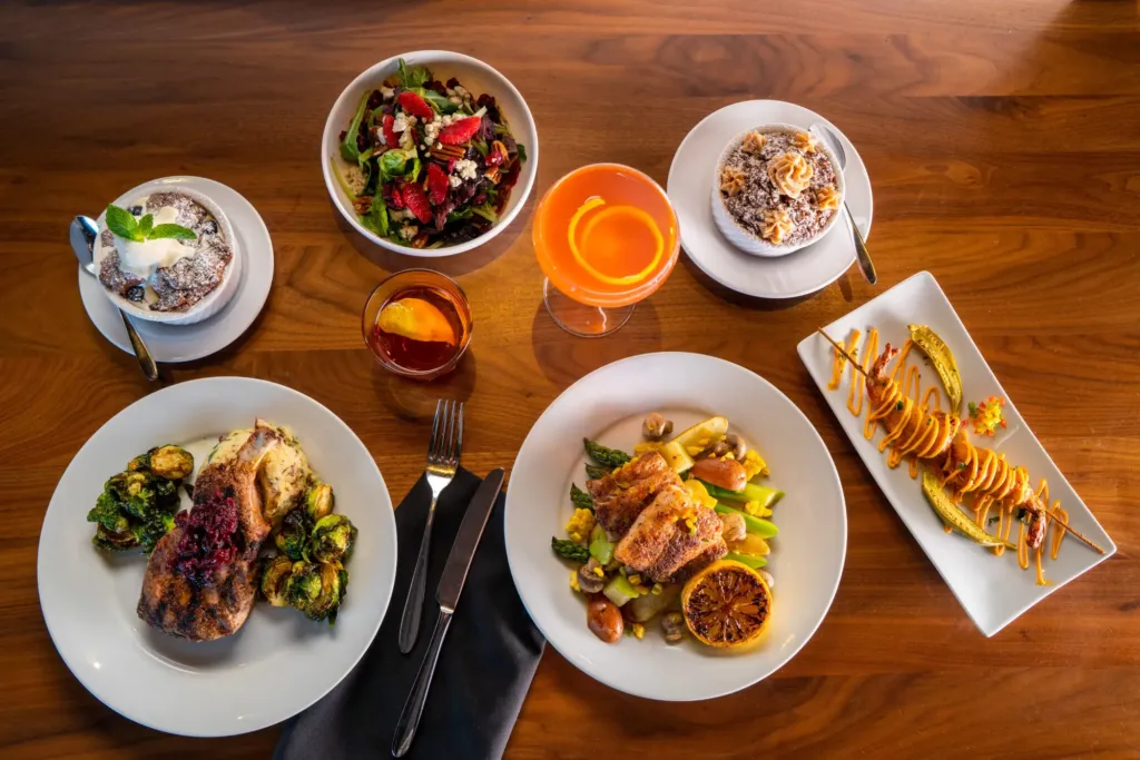a wooden table topped with plates of food
