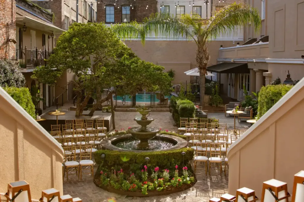a courtyard with a fountain surrounded by chairs